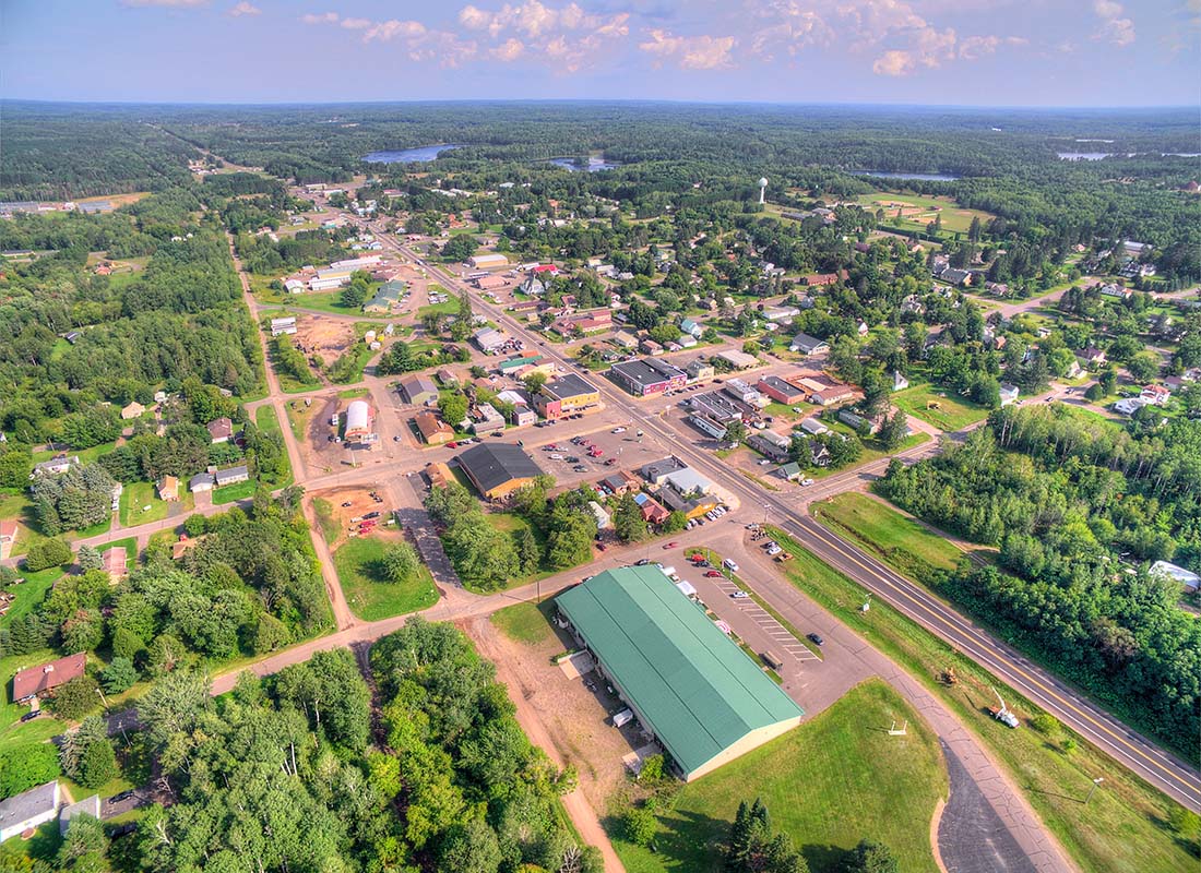 Greenville, WI - Aerial View of Buildings and Homes Surrounded by Bright Green Foliage in the Small Town of Greenville Wisconsin on a Sunny Day